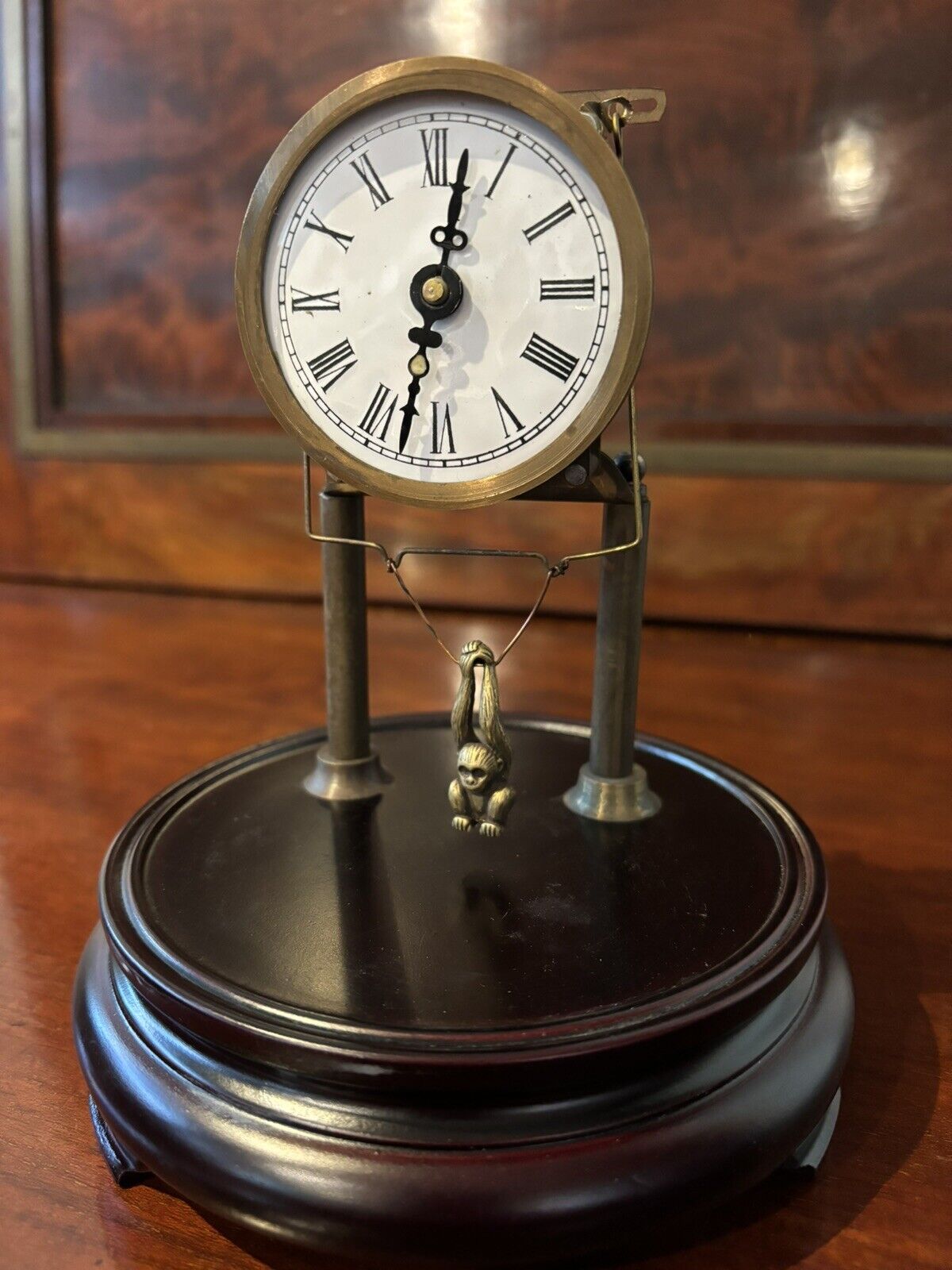 Skeleton Clock In Case With Swinging Monkey Pendulum.