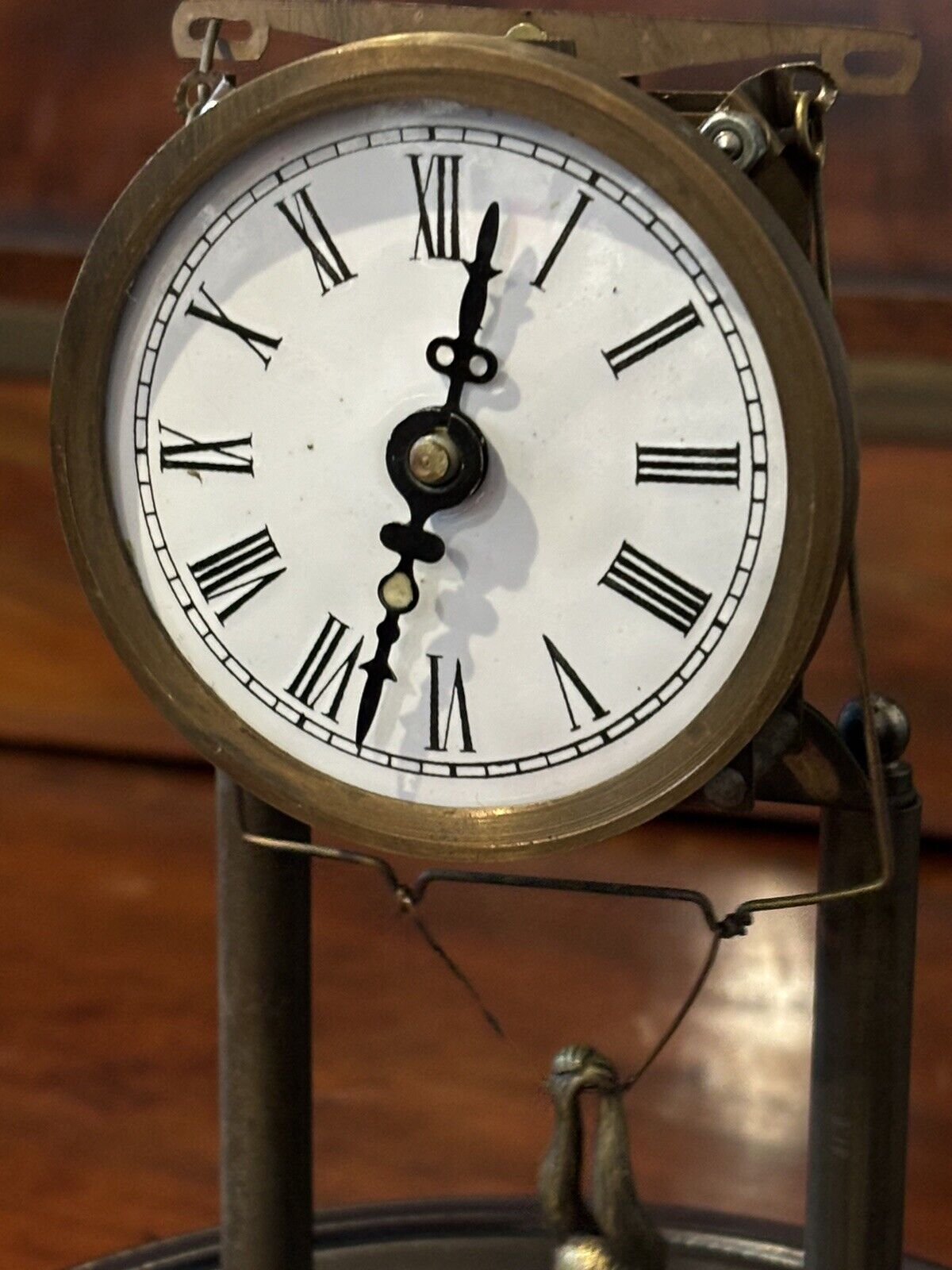 Skeleton Clock In Case With Swinging Monkey Pendulum.