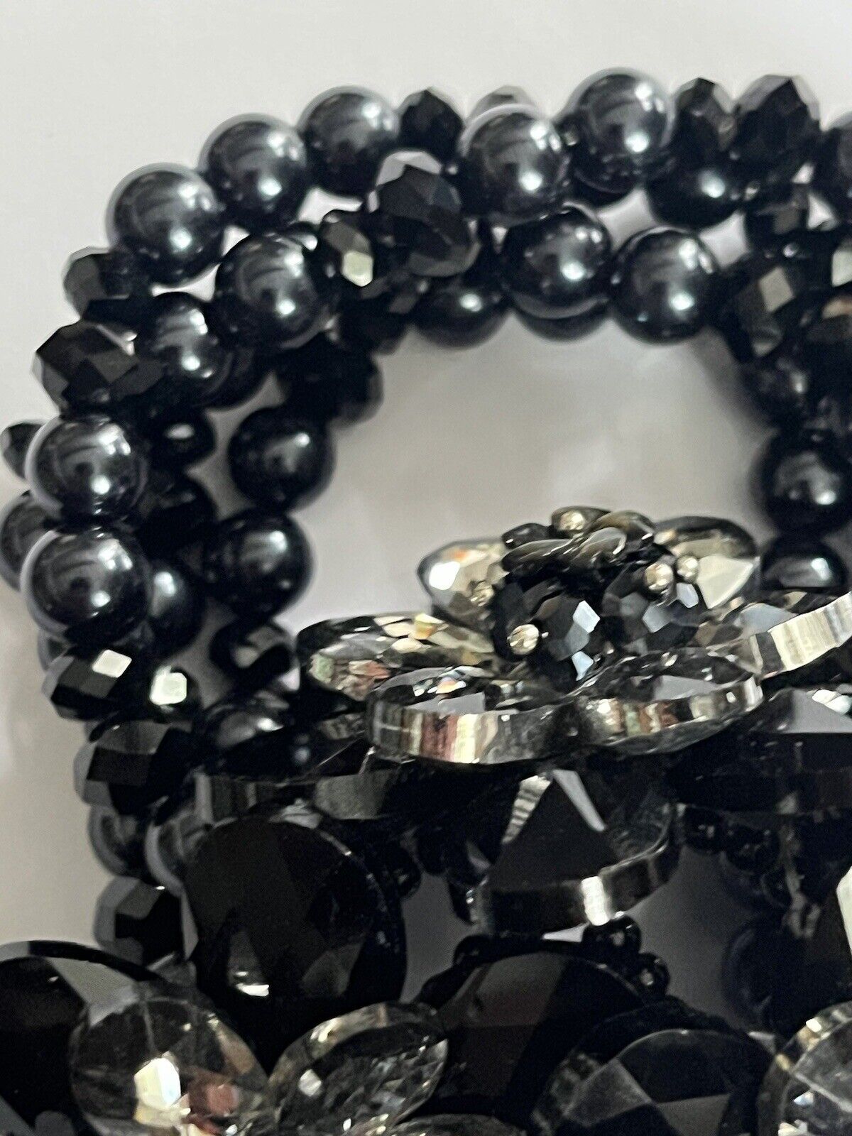 A BUTLER & WILSON Flower outlets Design Bracelet with black crystal petals and white mother of pearl centre